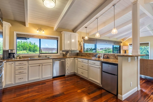 kitchen featuring kitchen peninsula, backsplash, white cabinetry, appliances with stainless steel finishes, and dark stone countertops