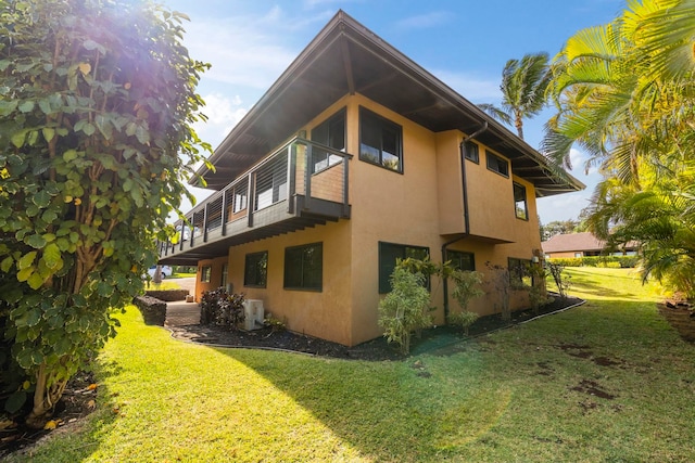 view of home's exterior featuring a yard