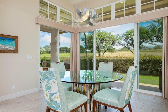 sunroom featuring a notable chandelier