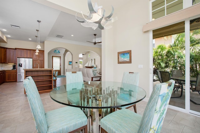 dining room featuring visible vents, arched walkways, crown molding, and recessed lighting