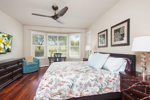 bedroom with ceiling fan and dark wood-style flooring