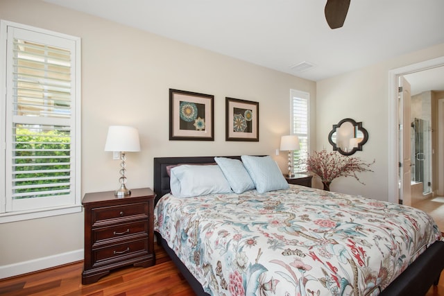 bedroom featuring ceiling fan, wood finished floors, visible vents, and baseboards