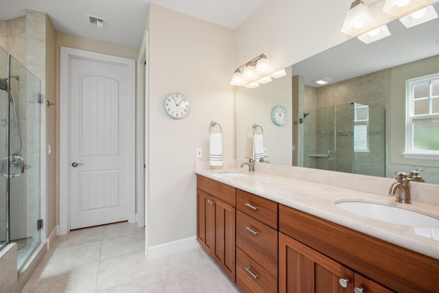 full bathroom with double vanity, a sink, visible vents, and a shower stall