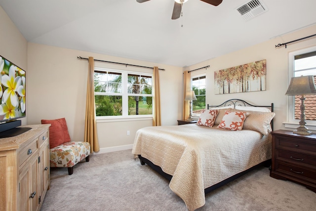 bedroom featuring lofted ceiling, visible vents, a ceiling fan, light carpet, and baseboards