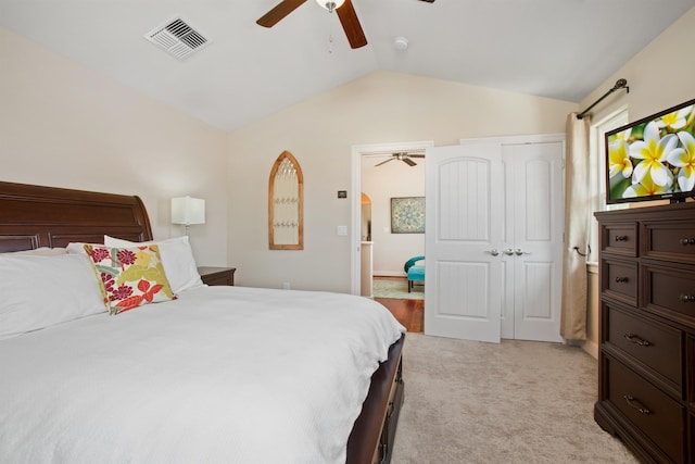 bedroom featuring vaulted ceiling, light carpet, visible vents, and a ceiling fan