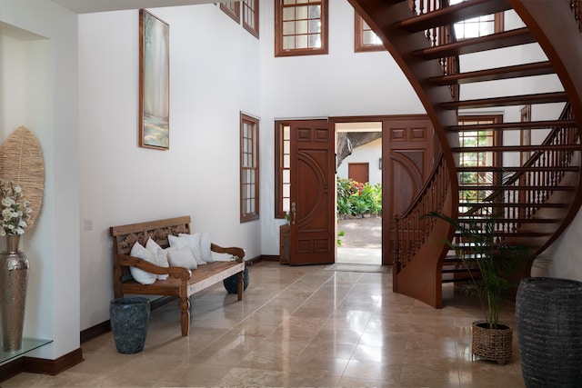 3002 S Kihei Rd, Kihei, HI 96753 - foyer with a high ceiling, stairway, plenty of natural light, and marble finish flooring