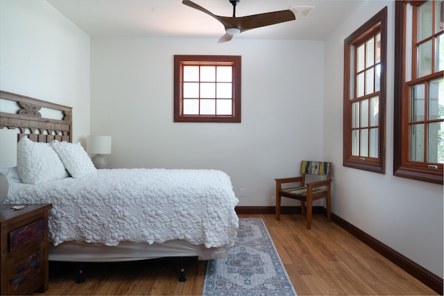 3002 S Kihei Rd, Kihei, HI 96753 - bedroom featuring multiple windows, wood finished floors, and a ceiling fan