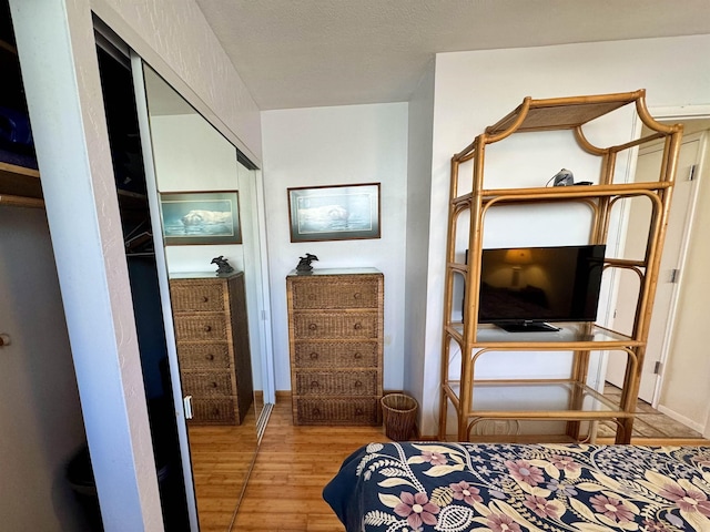 bedroom with baseboards and wood finished floors