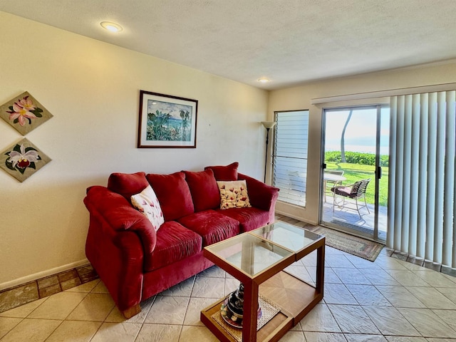 living area featuring baseboards and a textured ceiling