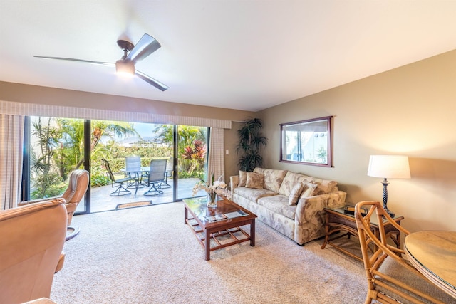 carpeted living room with ceiling fan