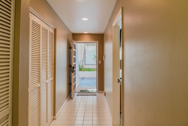 hall featuring light tile floors