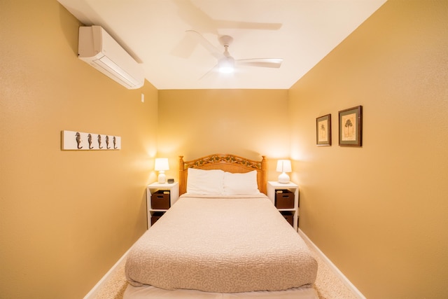 bedroom with ceiling fan, an AC wall unit, and carpet