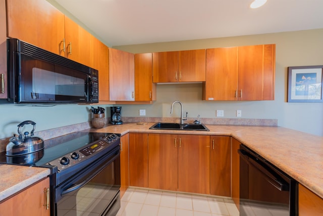 kitchen with sink, black appliances, and light tile floors