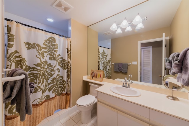 bathroom featuring tile flooring, toilet, and oversized vanity