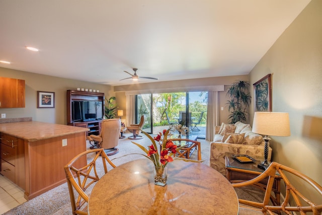 carpeted dining room featuring ceiling fan