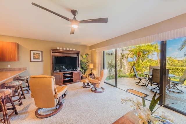 living room with ceiling fan and a healthy amount of sunlight