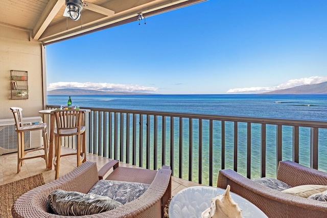 balcony featuring a water and mountain view