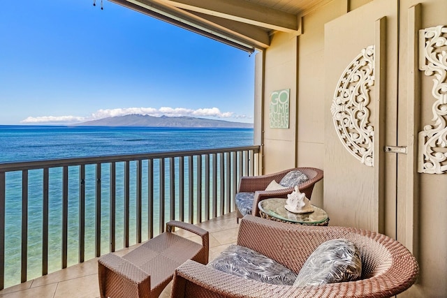 balcony featuring a water and mountain view