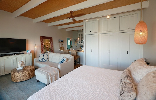 bedroom with beam ceiling and rail lighting