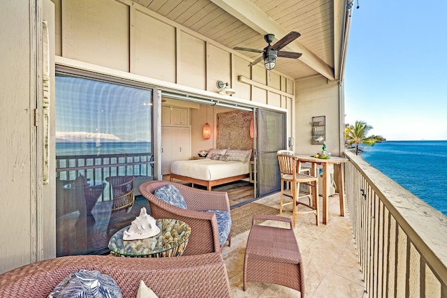 balcony with a water view and ceiling fan