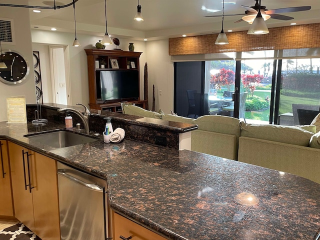 kitchen featuring tasteful backsplash, sink, stainless steel dishwasher, dark stone countertops, and ceiling fan