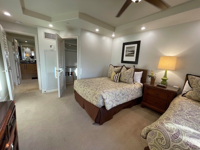 carpeted bedroom featuring ceiling fan and a closet