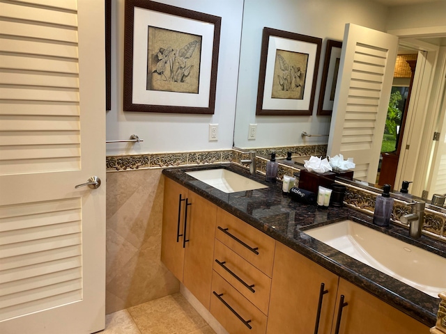 bathroom with dual vanity and tile patterned flooring