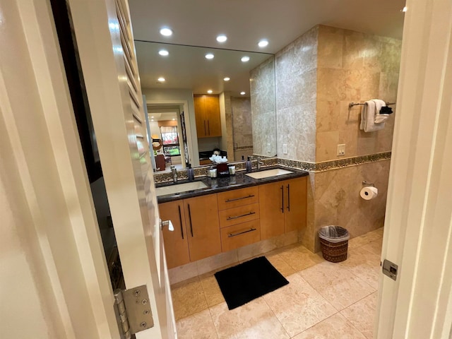 bathroom featuring double vanity, tile walls, and tile patterned floors