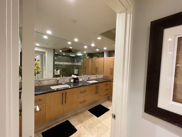 bathroom with tile patterned flooring, dual vanity, and decorative backsplash