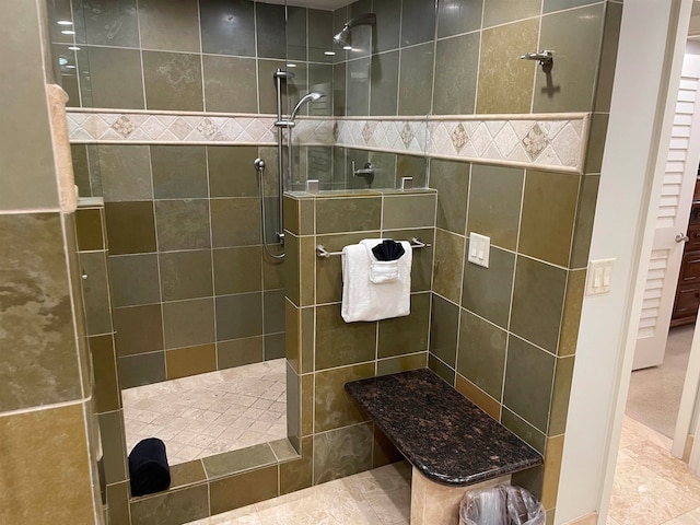 bathroom with tiled shower, tile walls, and tile patterned floors