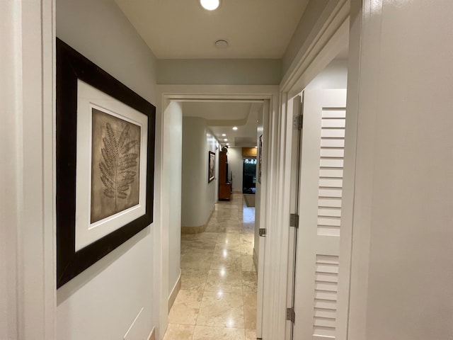 hall with light tile patterned flooring