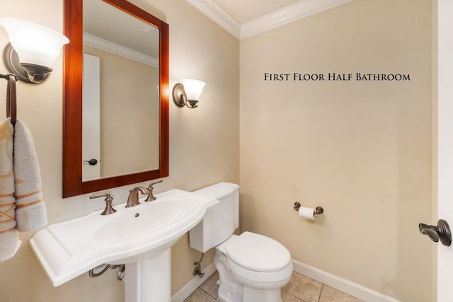 bathroom with tile patterned floors, ornamental molding, and toilet