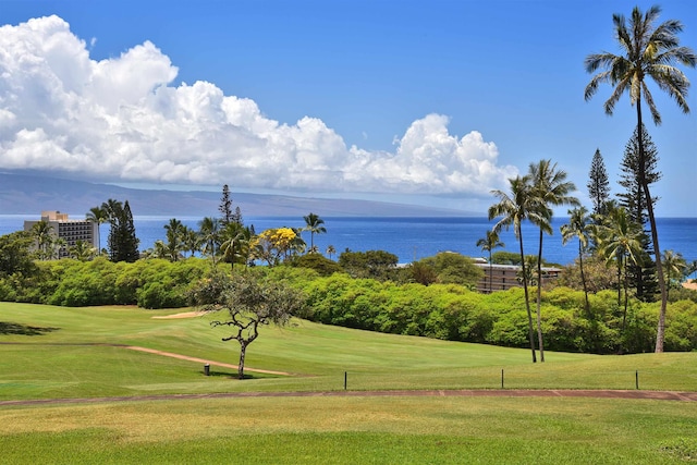 surrounding community featuring a yard, a water view, and view of golf course