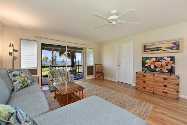 living room with ceiling fan, light wood finished floors, and baseboards