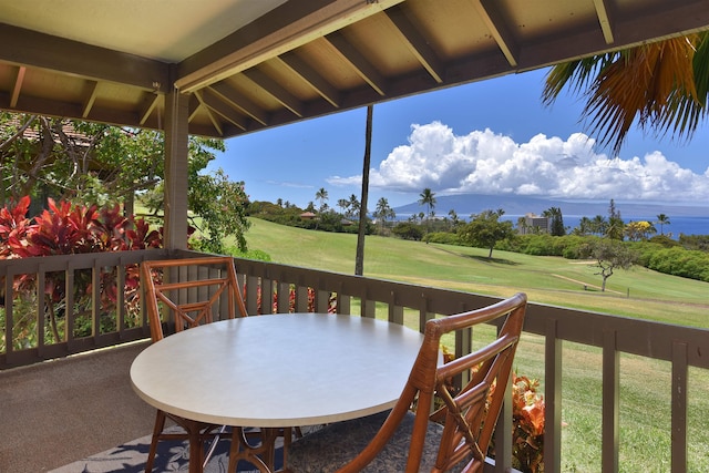 wooden terrace with a yard, outdoor dining area, and golf course view