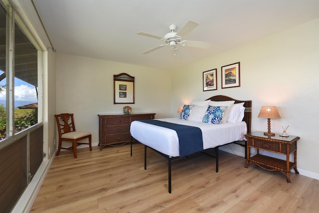bedroom featuring baseboards, ceiling fan, and light wood-style floors