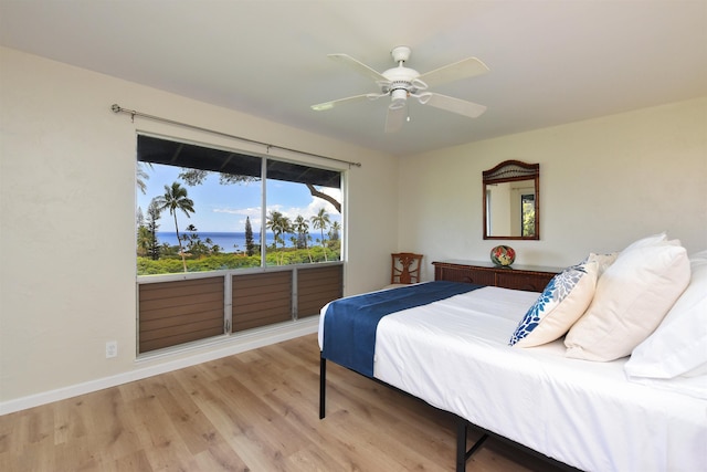 bedroom with baseboards, wood finished floors, and a ceiling fan