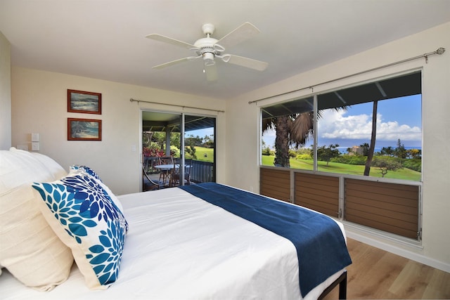 bedroom with access to exterior, a ceiling fan, and wood finished floors