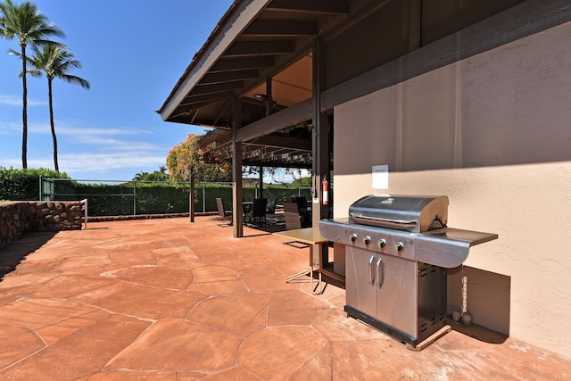 view of patio featuring fence and grilling area