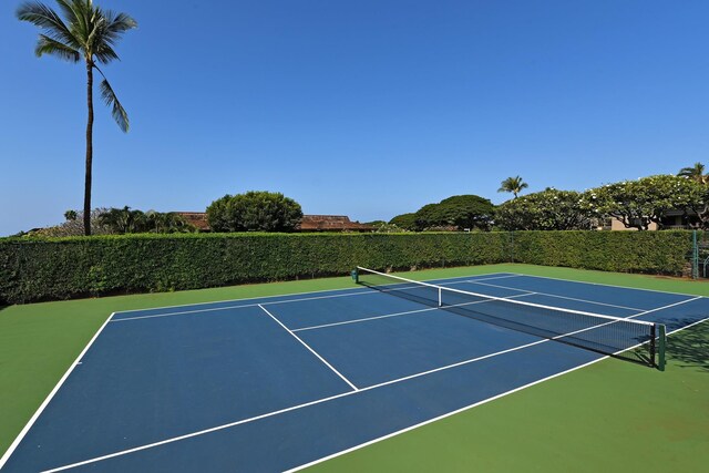 view of tennis court featuring fence and community basketball court