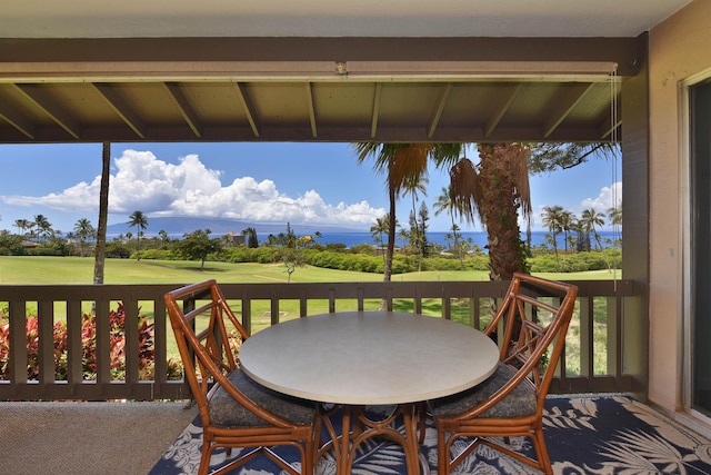 wooden deck with a yard, outdoor dining space, and golf course view