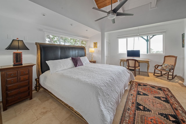 tiled bedroom featuring ceiling fan, vaulted ceiling, and multiple windows