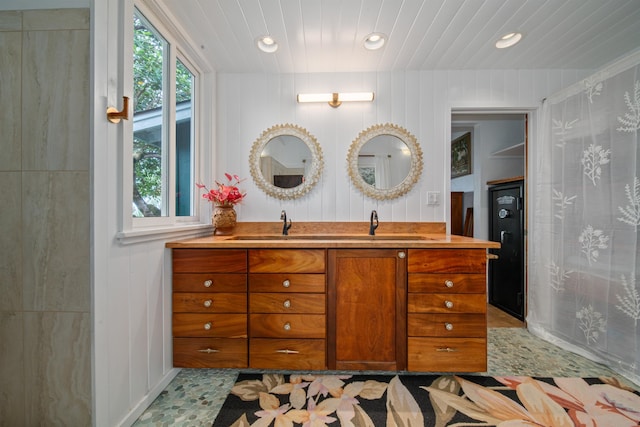 bathroom with tile floors, wood ceiling, and large vanity