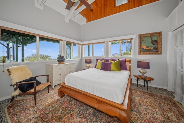 carpeted bedroom with high vaulted ceiling and ceiling fan