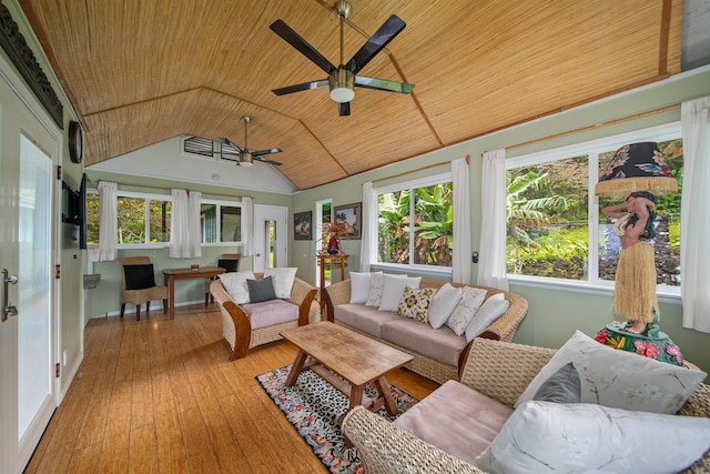 sunroom with ceiling fan, vaulted ceiling, and wooden ceiling