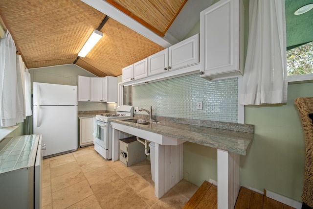 kitchen featuring white cabinetry, white appliances, sink, tasteful backsplash, and vaulted ceiling