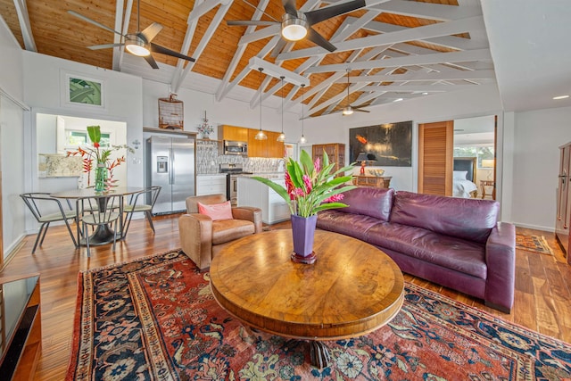 living room with ceiling fan, beam ceiling, hardwood / wood-style flooring, and wood ceiling