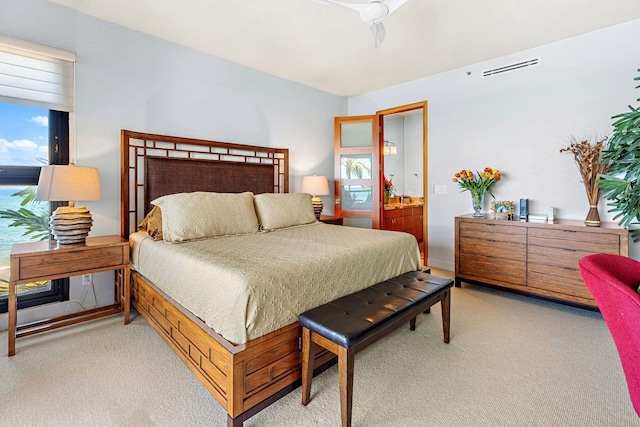 carpeted bedroom with ceiling fan and ensuite bathroom