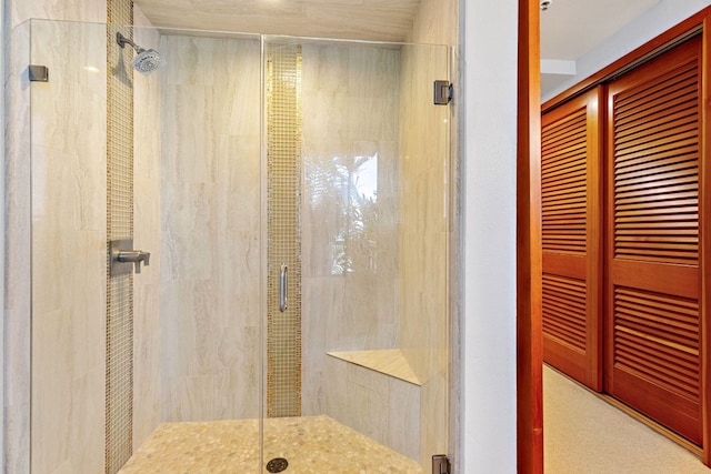 bathroom with a shower with door