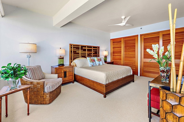 bedroom with ceiling fan, beamed ceiling, and carpet floors